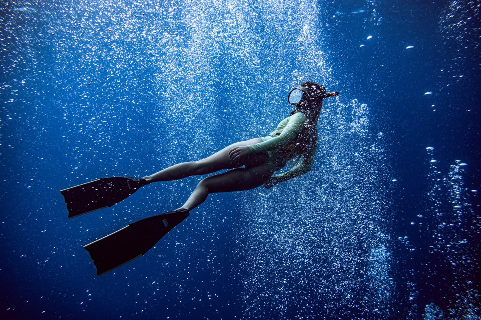 Snorkeler floating above a reef from overhead